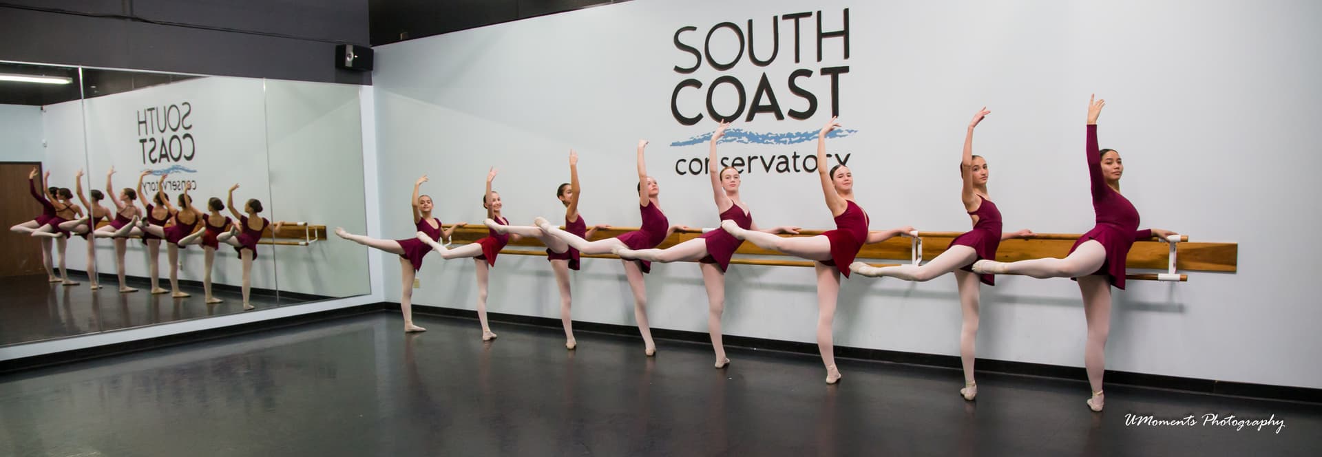 Ballet students training with focused technique at the barre